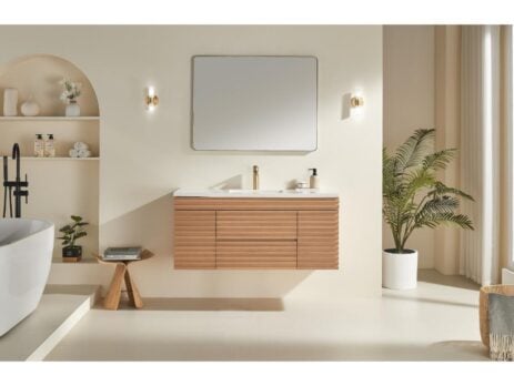 Minimalist bathroom featuring the Linea 48 Inch Wall Mounted Bathroom Vanity, a rectangular mirror, modern lighting, potted plant, decorative shelves, and a white freestanding tub in a bright, neutral-toned space.