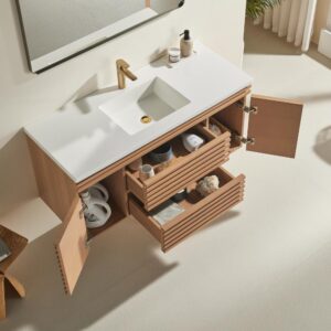 The Linea 48 Inch Wall Mounted Bathroom Vanity features a white countertop, gold faucet, and open drawers and cabinet doors displaying neatly organized toiletries and towels against a light-colored wall and floor.