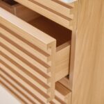 A close-up of the Linea 30 Inch Wall Mounted Bathroom Vanity, showcasing open slatted drawers, horizontal grooves, a modern design, and a light natural wood finish.