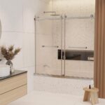 Modern bathroom with a Tub Door Double Sliding Frameless shower, white walls, terrazzo tiles, a light wood vanity with vessel sink, pampas grass decor, small wooden stool, and black recessed shower shelf.