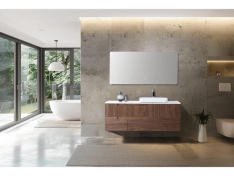 A modern bathroom showcases an Orsa 60 Inch Wall Mount Bathroom Vanity With Vessel Sink beneath a large mirror, with decorative accents. Expansive windows offer views of greenery and a freestanding tub, creating a bright, minimalist retreat.