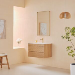 Minimalist bathroom with a Linea 30 Inch Wall Mounted Bathroom Vanity, white sink, gold faucet, rectangular mirror, wooden stool, potted plant, hanging wood light, sunlight through the window, and a vase of flowers.