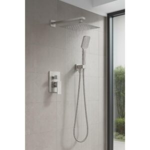 The Quadra Pressure Balanced Wall Mount Shower System features a large square overhead showerhead, a handheld attachment, and brushed metal controls, installed against light gray tiles beside a glass window.