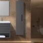 Modern bathroom with a floating gray vanity, rectangular mirror, Cartisan Design Side Cabinets, and a shower area highlighted by warm ambient lighting.