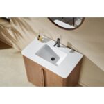 Overhead view of a modern bathroom featuring the Parma 36 Inch Bathroom Vanity With Top, with a white rectangular sink, sleek silver faucet, round mirror, and small accessories like a diffuser and bottle on the counter.