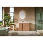 Modern bathroom with a green bathtub, Parma 48 Inch Bathroom Vanity With Top, oval backlit mirror, indoor plant, and glass shower. Large windows bring in natural light, and neutral tones with minimal decor create a serene vibe.