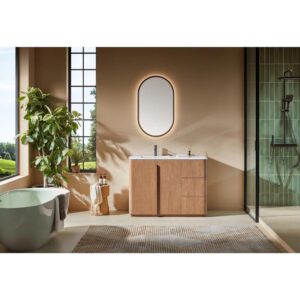 Modern bathroom with a green bathtub, Parma 48 Inch Bathroom Vanity With Top, oval backlit mirror, indoor plant, and glass shower. Large windows bring in natural light, and neutral tones with minimal decor create a serene vibe.
