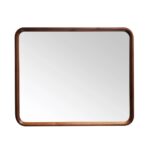 The Vela Mirrors feature a rectangular design with a smooth dark wood frame and rounded corners, shown here reflecting a simple white background.