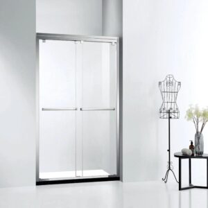 A modern bathroom features an ASD Cascade Shower Door – Bypass Sliding framed in silver, a black metal dress form, and a small table with a vase of flowers against a white wall.
