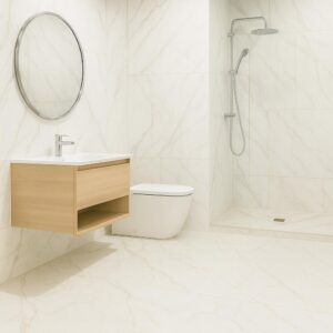 Minimalist bathroom with large format light marble tiles, a floating wooden vanity and round mirror, a modern white toilet, and an open shower area with a rainfall showerhead.