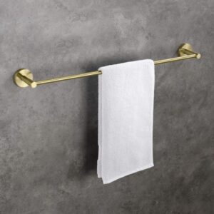 A white towel hangs neatly on a gold-colored towel bar mounted on a gray, textured wall.