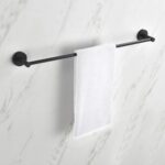 A white hand towel hangs neatly on a black Halo Bathroom Towel Bar, which is mounted on a white marble-patterned wall.
