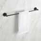 A white hand towel hangs neatly on a black Halo Bathroom Towel Bar, which is mounted on a white marble-patterned wall.