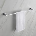 A white towel neatly hangs on the modern Quadra Bathroom Towel Bar, which is mounted on a light-colored marble wall.