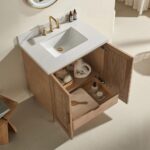 The Liora 36 Inch Bathroom Vanity showcases a white sink, gold faucet, and open wooden doors with organized essentials inside, all in a light neutral palette for a serene bathroom look.