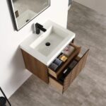 The Lille Wall Mounted Bathroom Vanity includes a white rectangular sink, a black faucet, and two open wooden drawers, perfectly organized with bathroom essentials, all highlighted by a modern gray tiled floor.