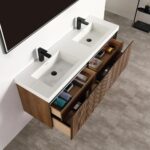 The Lille Wall Mounted Bathroom Vanity showcases a white countertop, dual rectangular sinks, black faucets, and wooden drawers for organized storage, all beautifully set against a gray tiled floor.