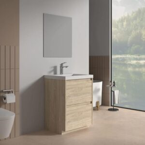 A modern bathroom featuring the Arvia 24 inch Bathroom Vanity with Sink, a wall-mounted faucet, large mirror, toilet, toilet paper holder, and floor-to-ceiling window overlooking a green forest and lake.