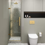 Modern bathroom with a Nova Hinged Frameless Shower Door, terrazzo wall shower and gold fixtures, wall-mounted toilet with gold flush plate, and shelves with toiletries above the toilet.