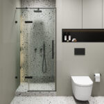 Modern bathroom with a Nova Hinged Frameless Shower Door, terrazzo walls and floor, wall-mounted showerhead, black fixtures, a wall-mounted toilet to the right, toilet paper holder, and shelf with toiletries.