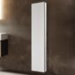 The Royale 15 inch × 70 inch Side Tall Medicine Cabinet with a white frame is mounted vertically on a brown textured wall in a modern interior space.