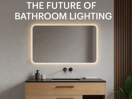 A modern bathroom with a floating wooden vanity, black sink, accessories, and a large rectangular LED mirror glowing softly. Text above reads, “WHY LED MIRRORS ARE THE FUTURE OF BATHROOM LIGHTING.”.