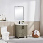 A modern bathroom with the Basel 24 Inch Bathroom Vanity featuring a white countertop and sink, topped by a rectangular mirror; towels in a basket and neutral walls with light wood paneling and curtains complete the look.