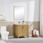 A minimalist bathroom showcases the Basel 30 Inch Bathroom Vanity with a spacious rectangular mirror above, a toilet to the left, and a brown basket holding a white towel on the floor near white curtains.