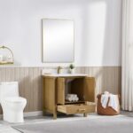 A modern bathroom features a toilet, Basel 30 Inch Bathroom Vanity with open storage showing towels, a rectangular mirror, potted plant, round wall shelf, basket of towels, and a large window with white curtains.