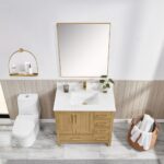 Modern bathroom with a Basel 36 Inch Bathroom Vanity, white sink, gold faucet, potted plant, toilet, wall mirror, shelf with toiletries, and a basket of rolled towels on a marble floor.