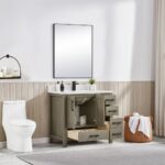 A modern bathroom features the Basel 36 Inch Bathroom Vanity with open storage, a large mirror, and a towel-filled wicker basket. Light wood paneling, white walls, and a sheer curtain add to the serene atmosphere.