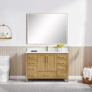 A bathroom with the Basel 48 Inch Bathroom Vanity in light wood, a white countertop, and a large rectangular mirror. A toilet sits left, topped by a gold wall shelf. White walls and wood paneling below add warmth.