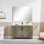 A modern bathroom showcases a Basel 48 Inch Bathroom Vanity with drawers, white countertop, black faucet, large rectangular mirror above, toilet to the left, and light wood paneling below crisp white painted walls.