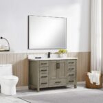 Modern bathroom with a large framed mirror above the Basel 48 Inch Bathroom Vanity, which features drawers, cabinets, a white countertop, nearby faucet and toilet, a round wall light, and a basket of towels on the floor.