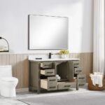 A modern bathroom with a Basel 48 Inch Bathroom Vanity with a white countertop, open drawers and cabinet doors, a large mirror above, toilet, towel basket, and wood wall paneling.