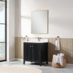 A modern bathroom features the Torino 30 Inch Bathroom Vanity Cabinet in black with gold handles, a white countertop, a gold faucet, a large gold-framed mirror, gold towel rings with white towels, and a basket of towels on a marble floor.
