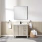 A modern bathroom features a square mirror above a Torino 36 Inch Bathroom Vanity Cabinet with Drawers, black faucet, two towel rings with white towels, and a wicker basket holding rolled towels on a tiled floor.