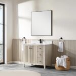A modern bathroom features the Torino 36 Inch Bathroom Vanity Cabinet with drawers, black faucet, square mirror, towel rings with white towels, and a woven basket on a gray tile floor. Sunlight streams in from a large window.