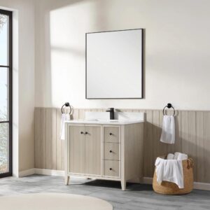 A modern bathroom features the Torino 36 Inch Bathroom Vanity Cabinet with drawers, black faucet, square mirror, towel rings with white towels, and a woven basket on a gray tile floor. Sunlight streams in from a large window.