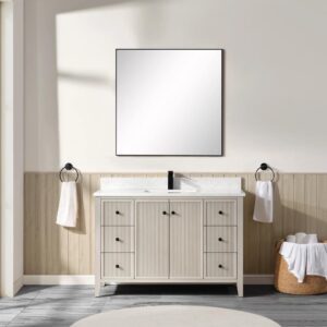 A bathroom featuring the Torino 48 Inch Bathroom Vanity with a white sink, a square mirror above, towel rings with white towels on both sides, a wicker basket with rolled towels on the right, and white walls with light wood paneling.