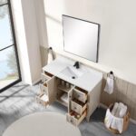 The Torino 48 Inch Bathroom Vanity Cabinet features a white countertop, rectangular sink, and black faucet. Four drawers and two cabinet doors reveal organized storage inside. A mirror, towels, and laundry basket complete the scene.