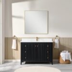 A modern bathroom features the Torino 48 Inch Bathroom Vanity Cabinet in black with a white countertop, large square mirror, gold fixtures, two towel rings holding white towels, and a basket of towels on a light wood-paneled wall.