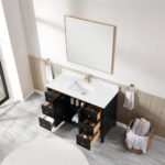 The Torino 48 Inch Bathroom Vanity Cabinet features a white sink and gold faucet, six open drawers, two cabinet doors, and is complemented by a large mirror above and a towel basket on the tiled floor.
