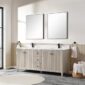 A modern bathroom featuring the Torino 72 Inch Double Sink Bathroom Vanity Cabinet, two rectangular mirrors, black faucets, hand towels on both sides, light wood cabinets, a large window for natural light, gray tile flooring, and a round rug.