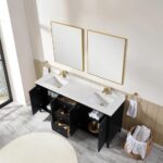 A modern bathroom features the Torino 72 Inch Double Sink Bathroom Vanity Cabinet with black cabinets, open doors and drawers, a white countertop, two gold-framed mirrors, gold faucets, towel rings with white towels, and a basket of rolled towels.