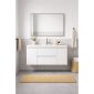 Modern bathroom with a Paterno 42 Inch Wall Mount Bathroom Vanity, wide mirror, beige towels, a woven basket, and natural fiber rug on gray tile floors. The space is minimalistic with neutral colors and clean lines.