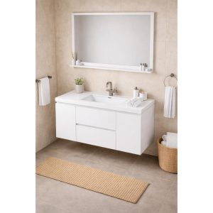 Modern bathroom with beige tile walls and floor, featuring a Paterno 42 Inch Wall Mount Bathroom Vanity with sink, a large rectangular mirror, towels on rings, a wicker basket, a narrow woven rug, and small plants and toiletries on the vanity and shelf.